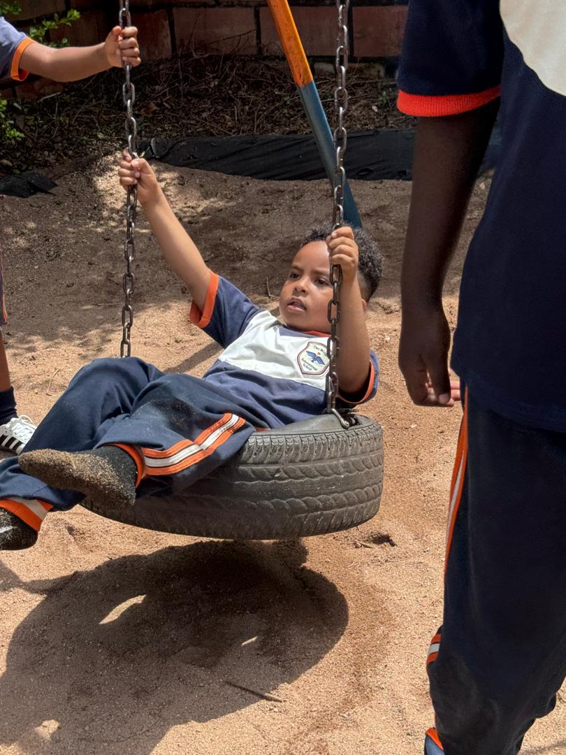 A learner enjoying the tire swing.