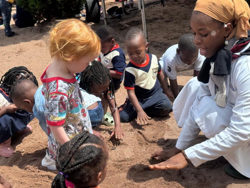 Students exploring the school grounds with a teacher.