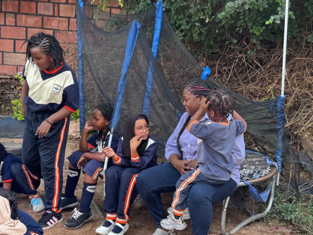 Learners taking a break near the trampoline.