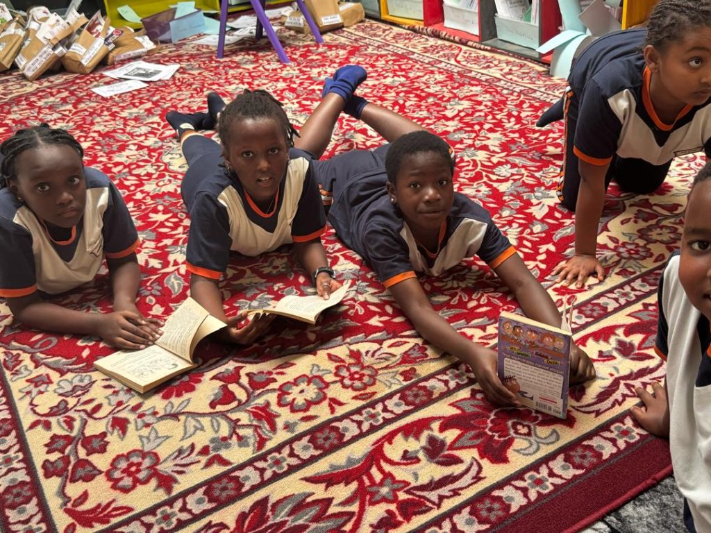 Learners reading together on the classroom rug.